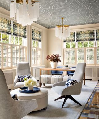 neutral living room with gray chairs and gray patterned ceiling