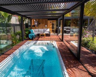 tropical garden with swim spa and decking by Consilium Hortus