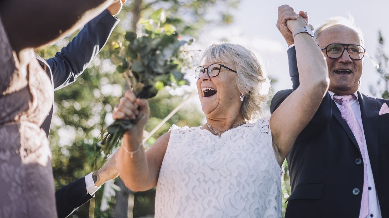 An older couple celebrate at their wedding.