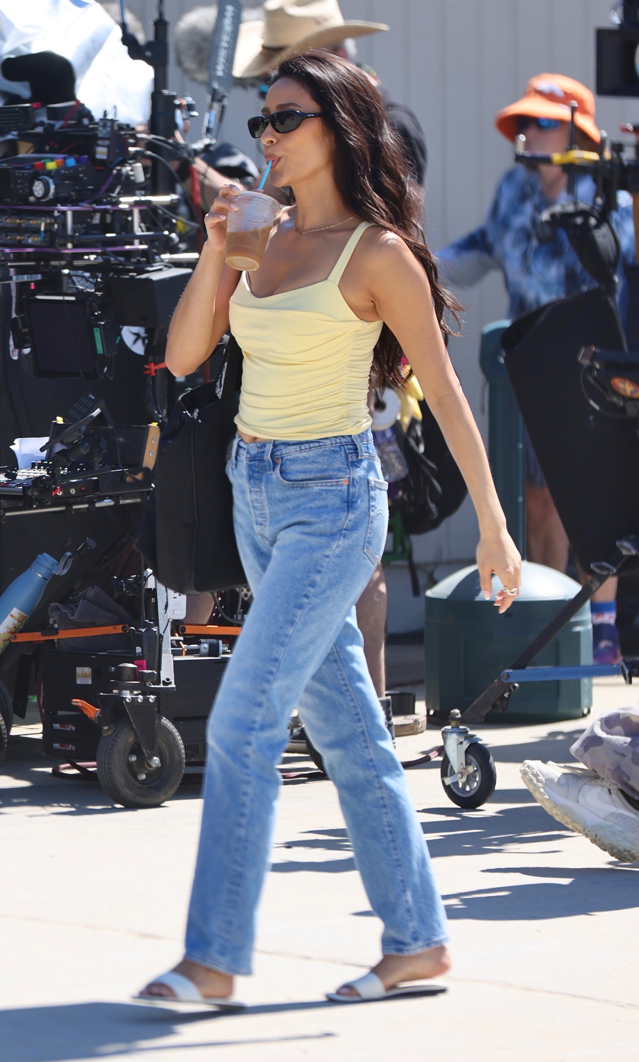 Shay Mitchell films the Baywatch reboot in Malibu wearing a yellow tank top and jeans