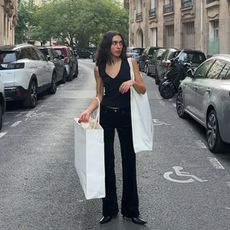 Camelia Farhoodi carrying shopping bags.