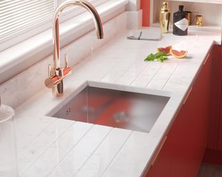 A bright kitchen with white quartz countertop and sink area