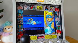 Evercade Alpha with Street Fighter Alpha 3 intro playing on screen