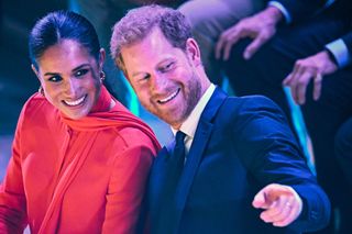 Britain's Meghan, Duchess of Sussex (L) and Britain's Prince Harry, Duke of Sussex, react as they attend the annual One Young World Summit at Bridgewater Hall in Manchester, north-west England on September 5, 2022.