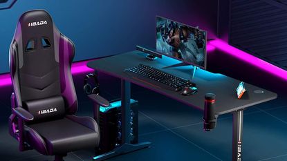 One of 2022's best gaming desks positioned to the side of a gaming chair