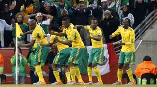 South Africa's players celebrate by the corner flag after Siphiwe Tshabalala's opening goal of the first match of the 2010 FIFA World Cup against Mexico on 11 June, 2010 in Johannesburg, South Africa