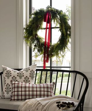 Wreath in window with red bow