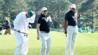 Lance Bennett, Rob McNamara and Tiger Woods during a practice round before The Masters