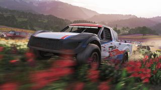 Some offroad cars blitz through colorful fields in Forza Horizon 6.