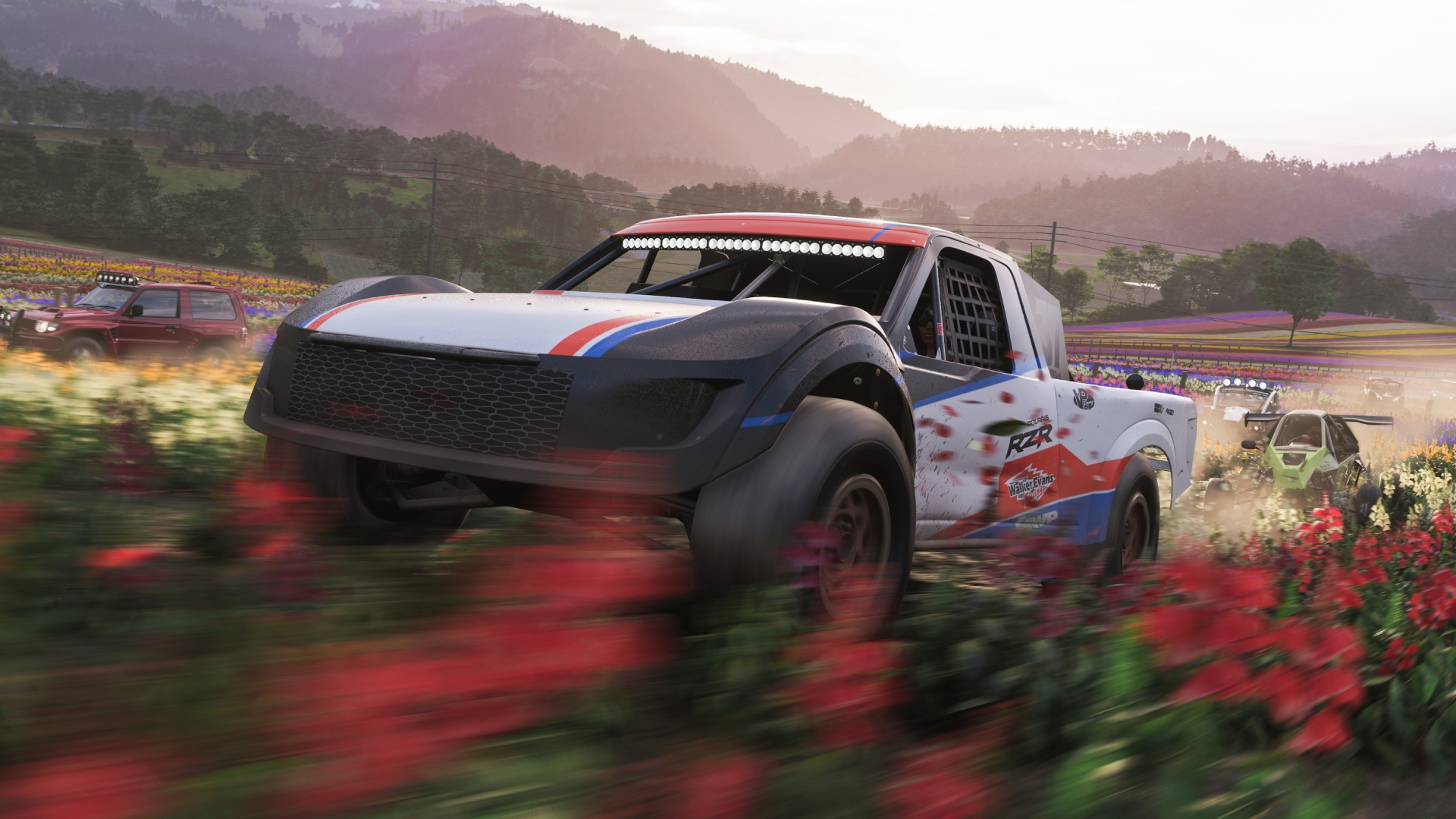 Some offroad cars blitz through colorful fields in Forza Horizon 6.