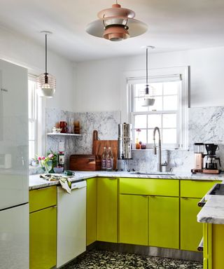 modern kitchen with bright green cabinets, white walls and marble countertops