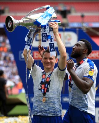 Tranmere's Connor Jennings celebrates with the trophy after the Sky Bet League Two play-off final at Wembley