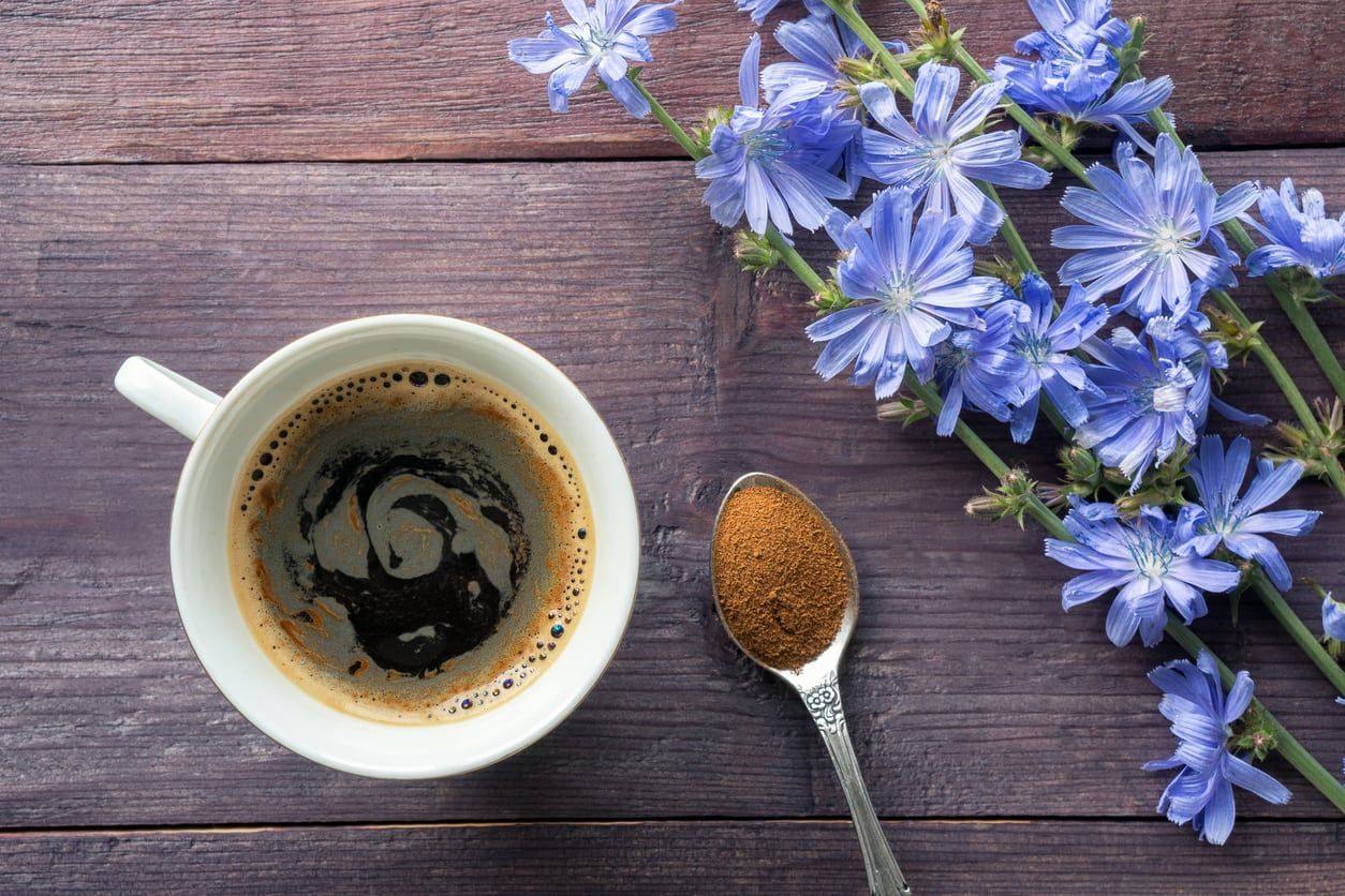 Purple Flowers Next To Cup Of Coffee