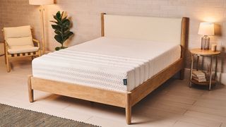 The Leesa Legend Hybrid Mattress on a wooden bed frame in a bedroom