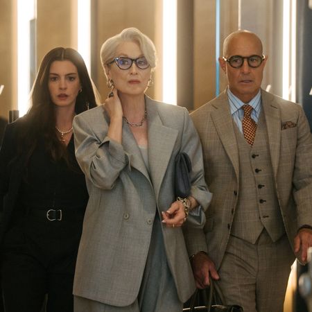 Anne Hathaway as Andy Sachs, Meryl Streep as Miranda Priestly and Stanley Tucci as Nigel Kipling wearing suits and walking through the halls of dior in the devil wears prada 2