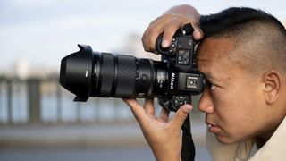 Nikon Z 24-70mm f/2.8 S II lens in the hand