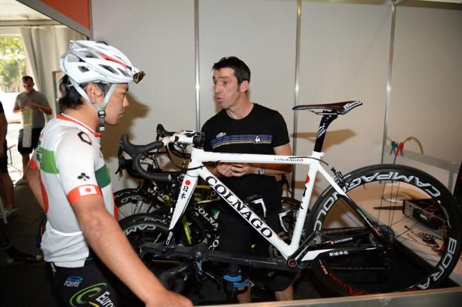 Yukiya Arashiro looks over his Colnago race bike
