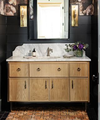 Dark powder room with panelled walls and wallpaper