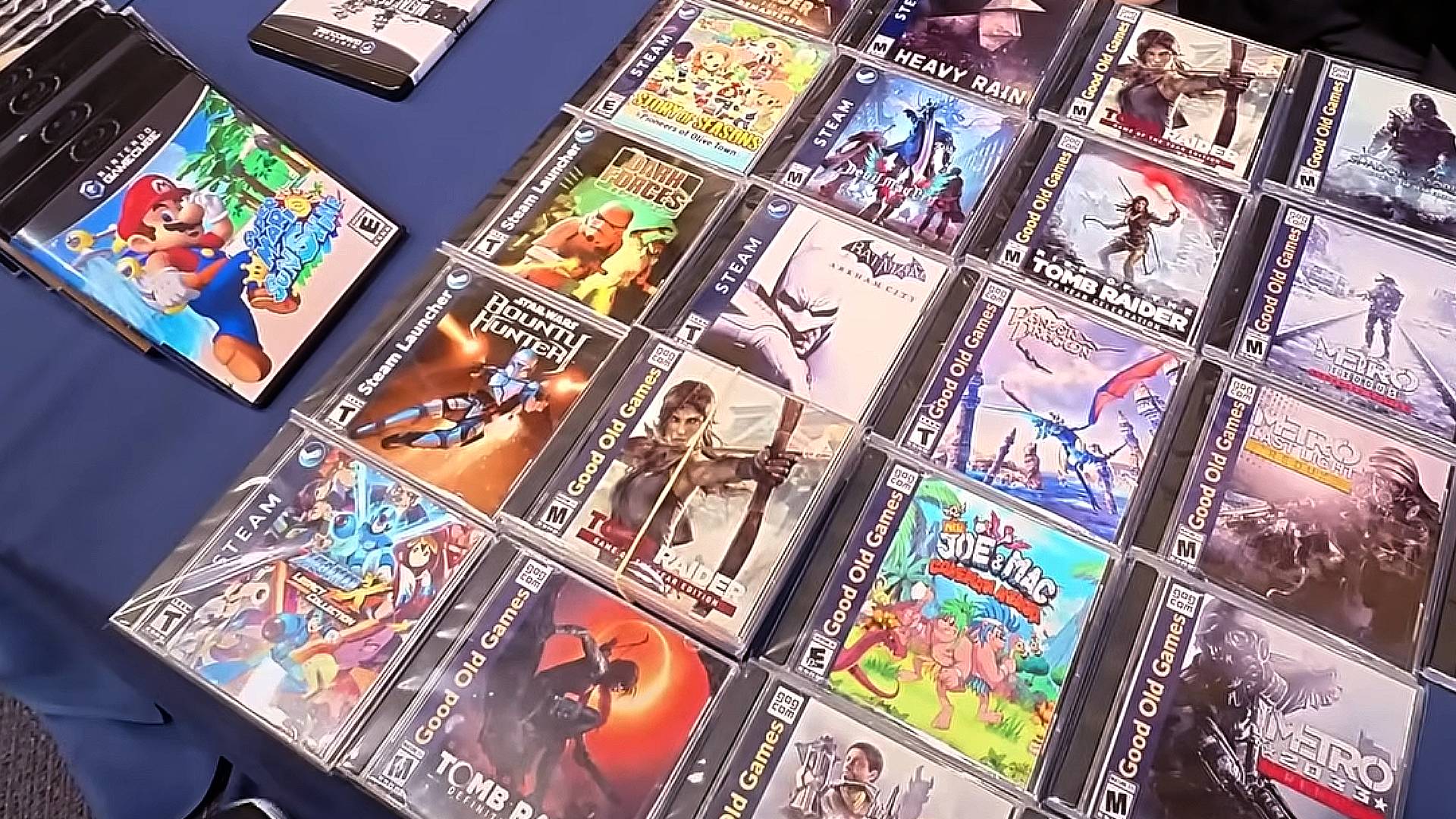Table with custom physical PC games on blue cover.