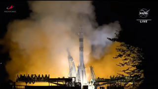 A white and green Russian rocket launches into the night sky on Sept. 15, 2023