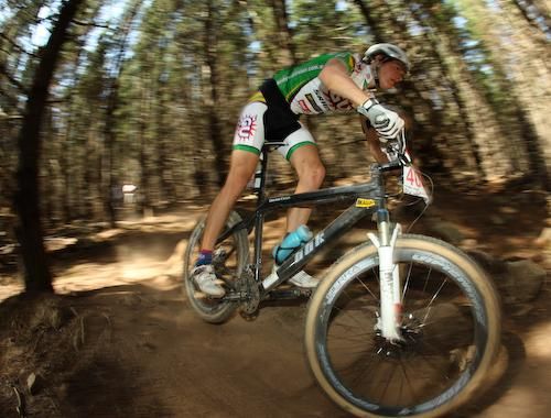A GU old &amp; young rider corners on the course.