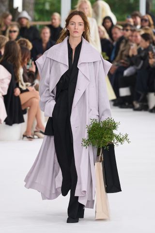 Model wears lilac on the Issey Miyake SS25 runway.