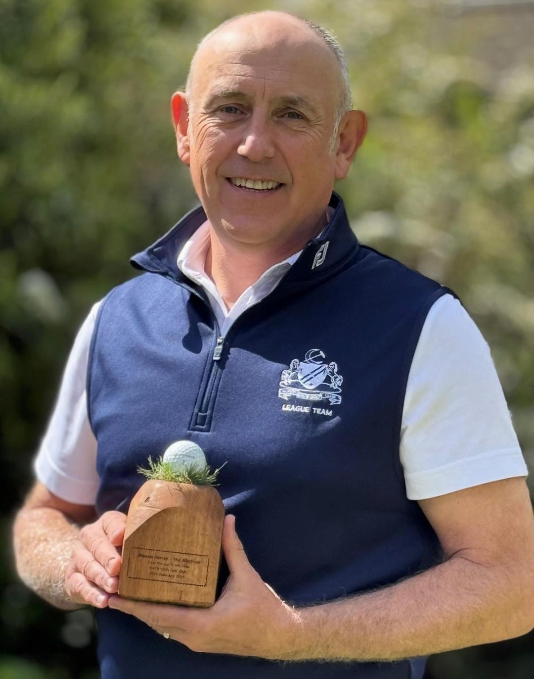 Graham Harvey poses with the trophy made by Nigel West to hold the ball with which he made his albatross