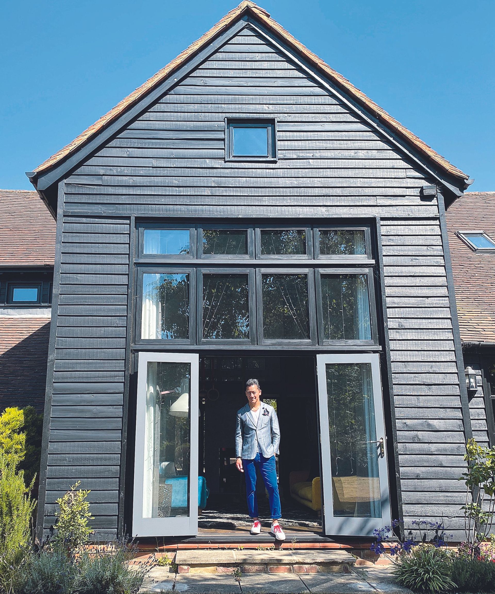 Black wooden exterior, glass windows and doors