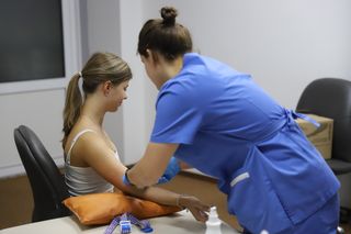 Doctor gives the patient an injection into a vein