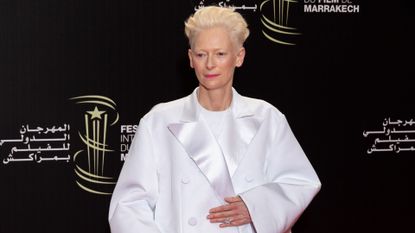 Tilda Swinton in an oversized white coat at the 2023 Marrakech International Film Festival in Morocco