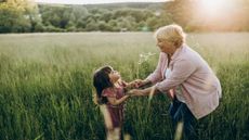 Grandmother and granddaughter in a field
