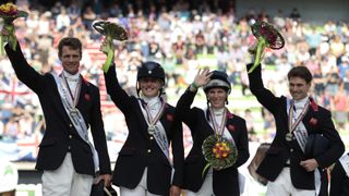 William Fo-Pitt, Kristina Cook, Zara Phillips and Harry Meade celebrate during the podium ceremony for the Jumping event of the 2014 FEI World Equestrian Games, on August 31, 2014 in France