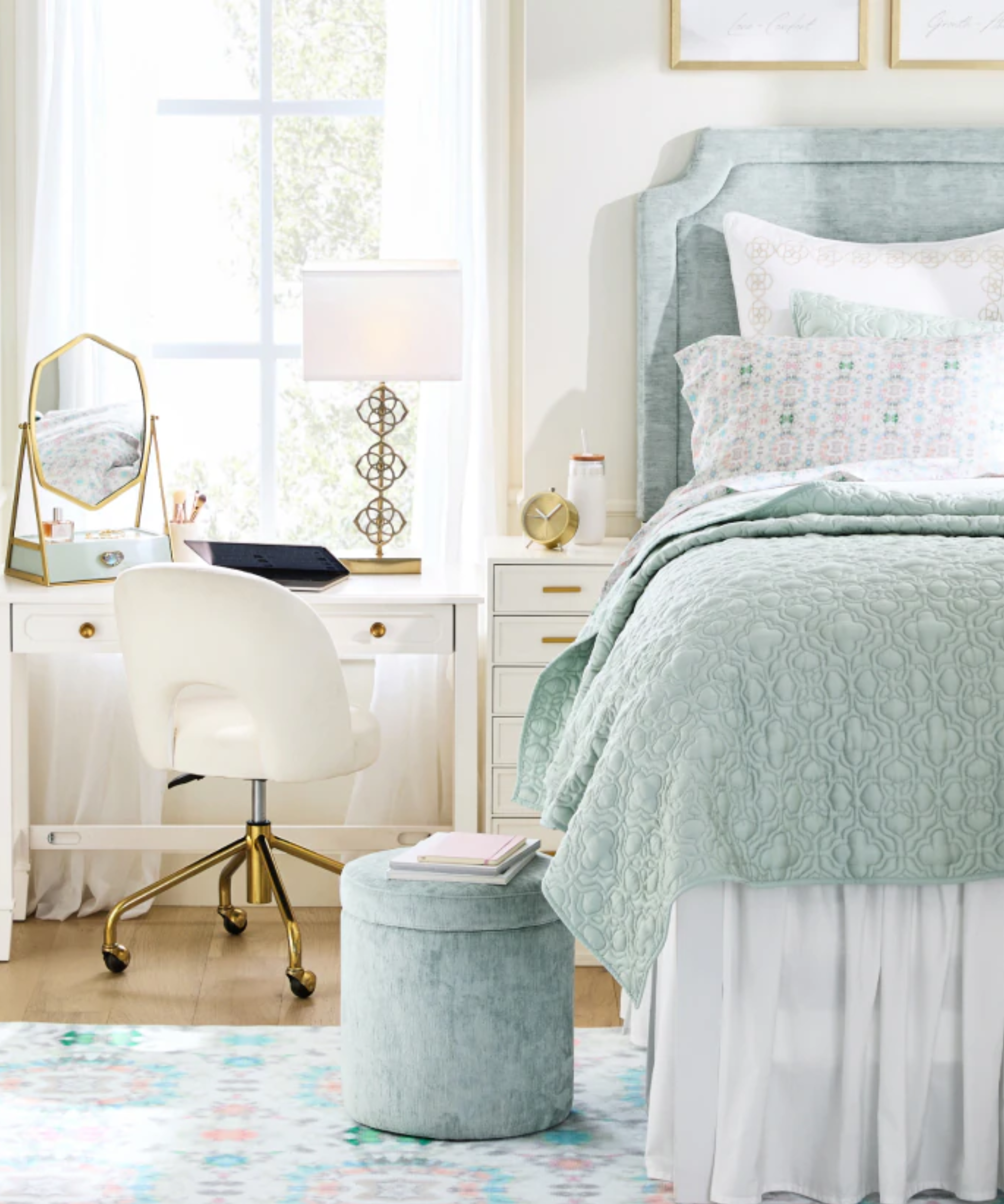 a dorm room with a light blue color scheme and a white desk and swivel chair next to the bed