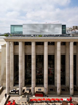 Daytime, outside image of the Nomiya Restaurant, Palais Tokyo, Paris, on top of a tall stone column building, blue cloudy sky