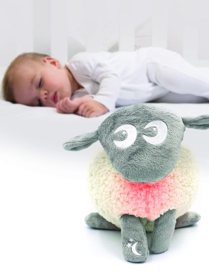 baby sleeping with toy sheep