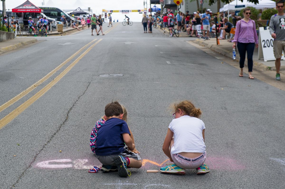 Fans chalk the names of their favourite riders on the road pre-stage