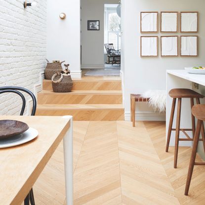 Open plan kitchen dining room area with wooden parquet flooring 