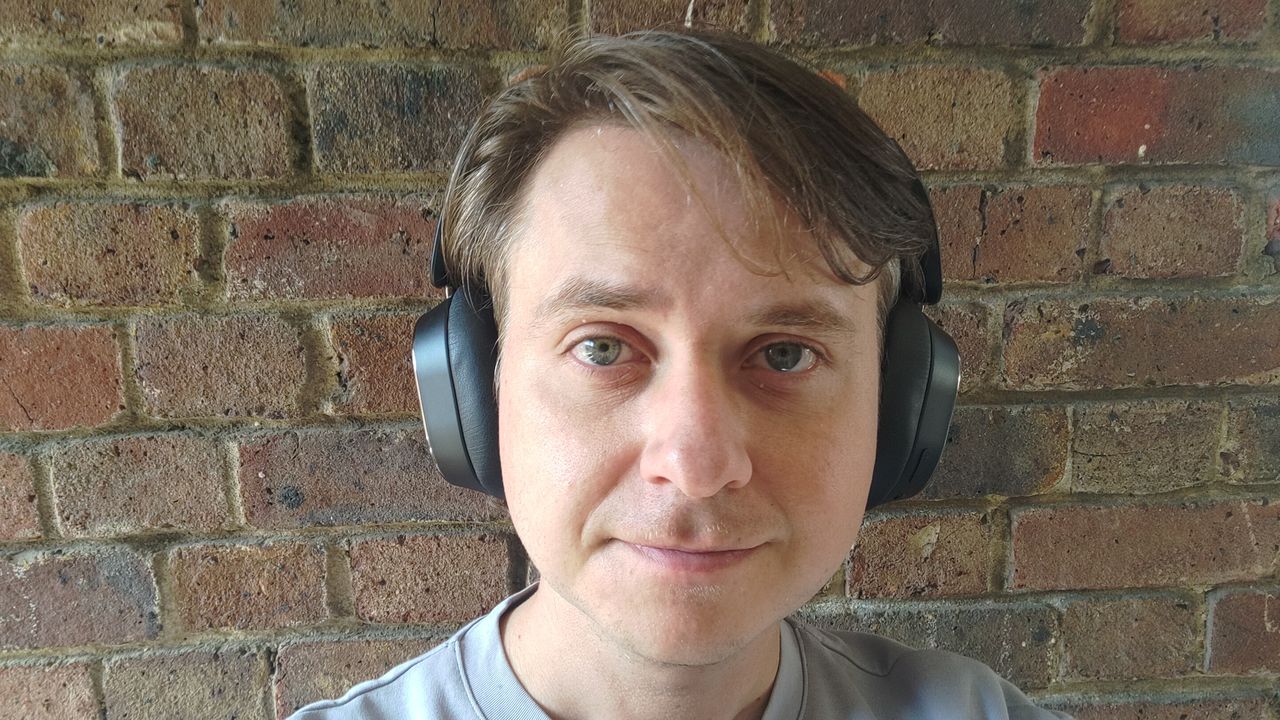Photograph of man wearing FiiO EH13 headphones