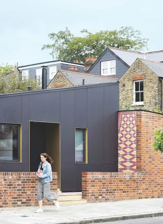 black cladding and tiles on exterior of self build