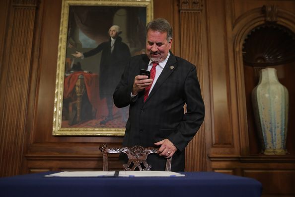 Rep. Doug LaMalfa of California uses his phone to take a picture of the legislation to repeal the Affordable Care Act.