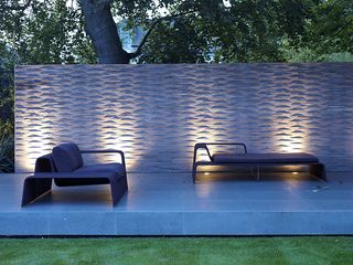 textured garden wall uplit with outdoor lighting