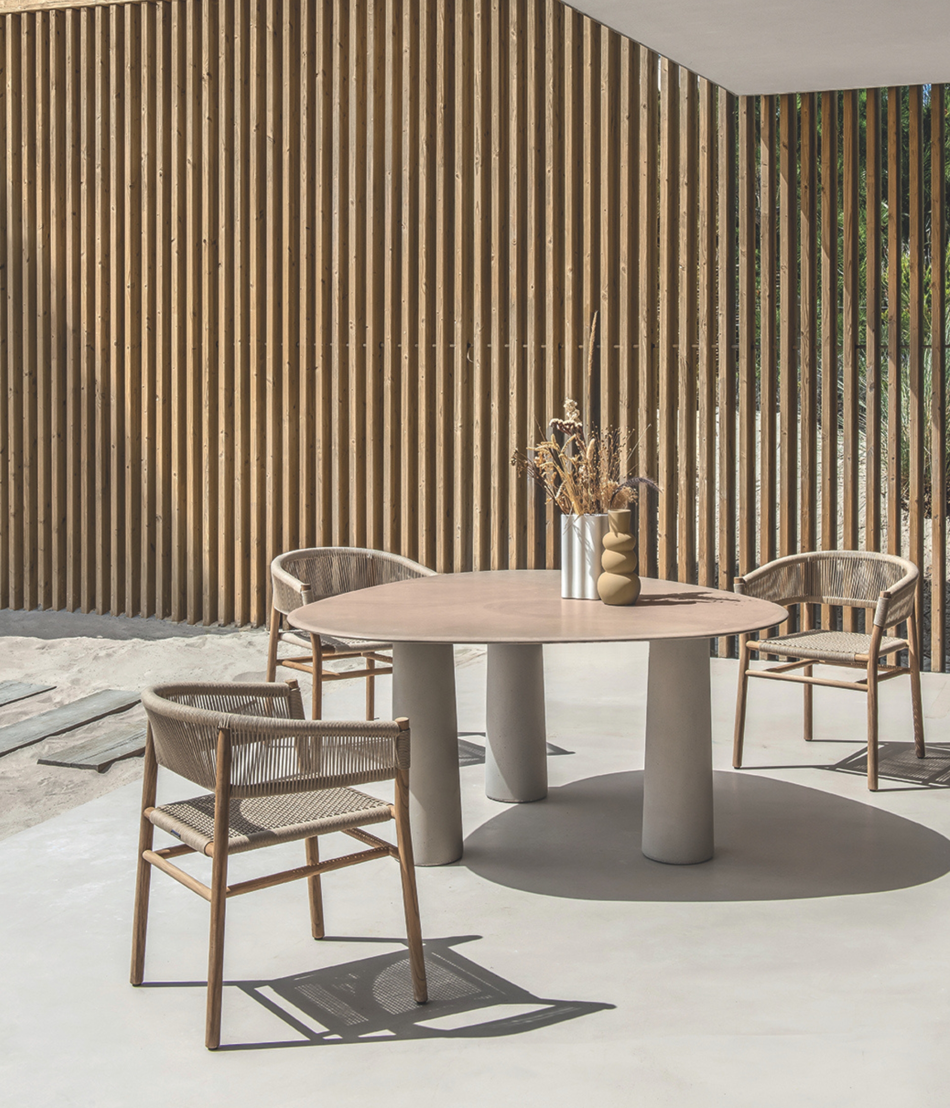 a neutral outdoor table set against a privacy fence on a patio