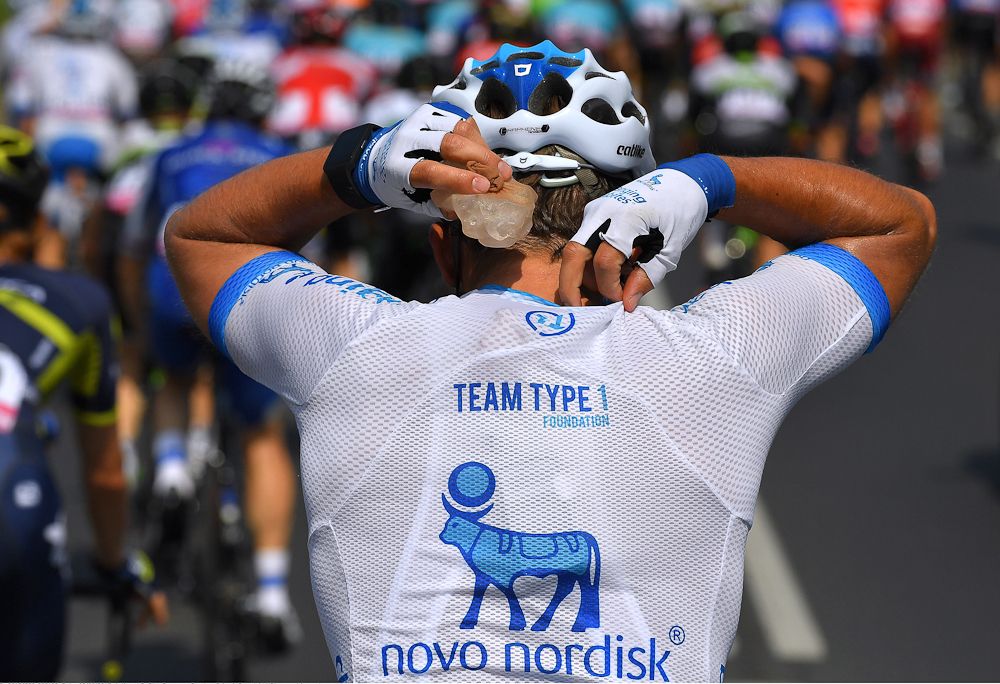 A Novo Nordisk rider adds some ice to his jersey at the Tour of Poland