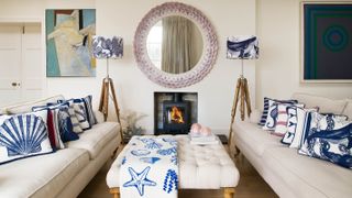 living room with cream sofas and blue and white cushions