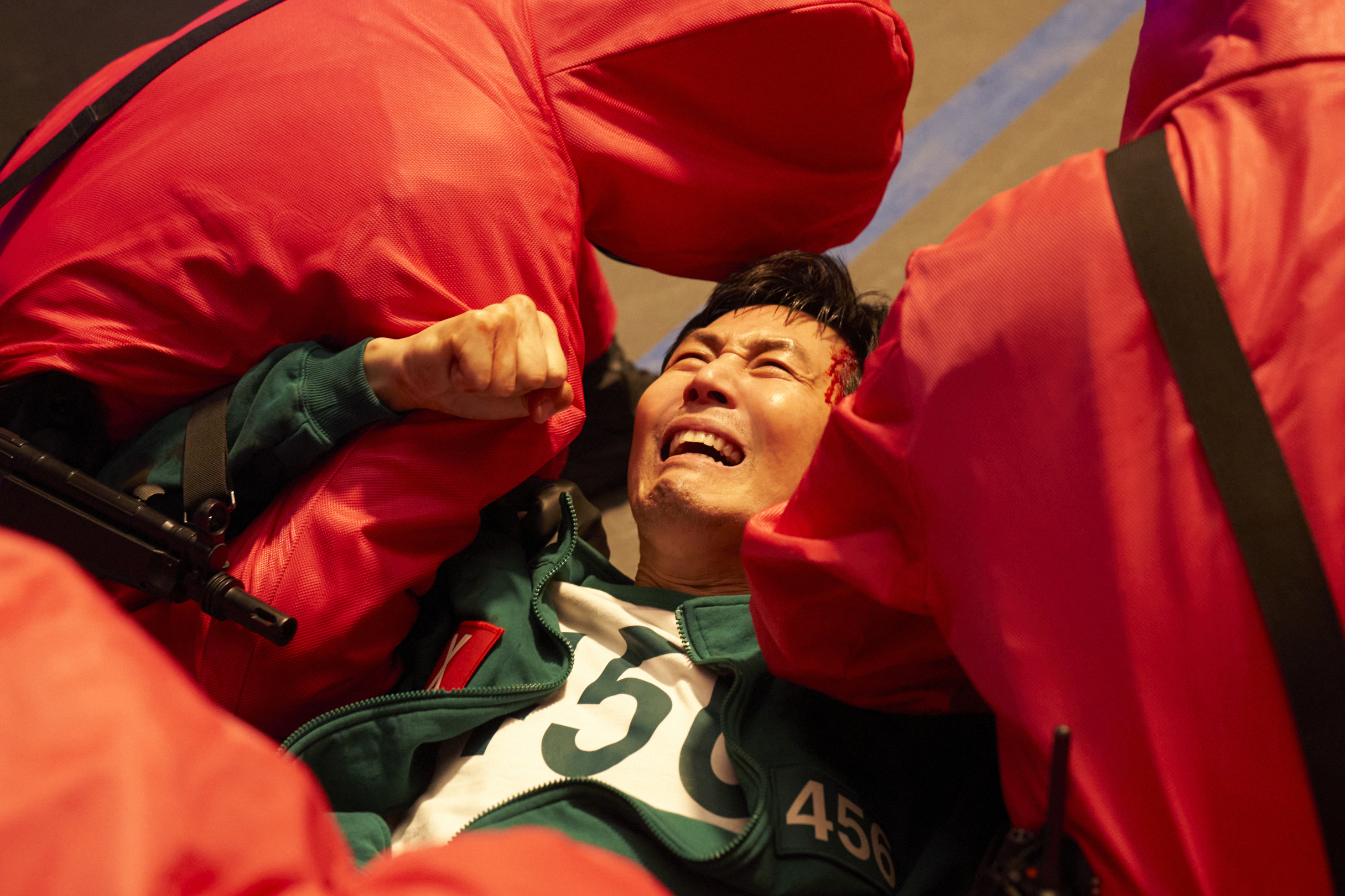 Gi-hun (Lee Jun-jae) is held down by guards, in 'Squid Game' season 3.