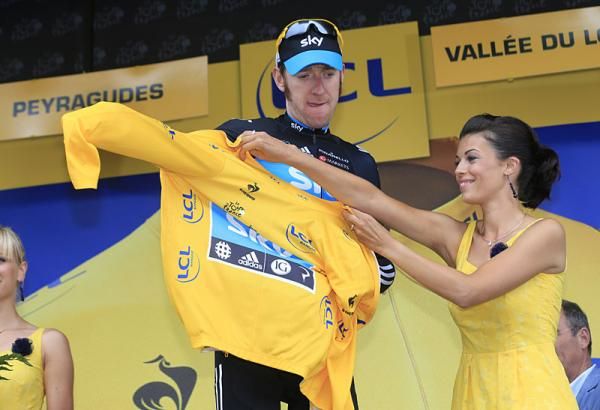 Bradley Wiggins (Sky) puts on the yellow jersey on the podium