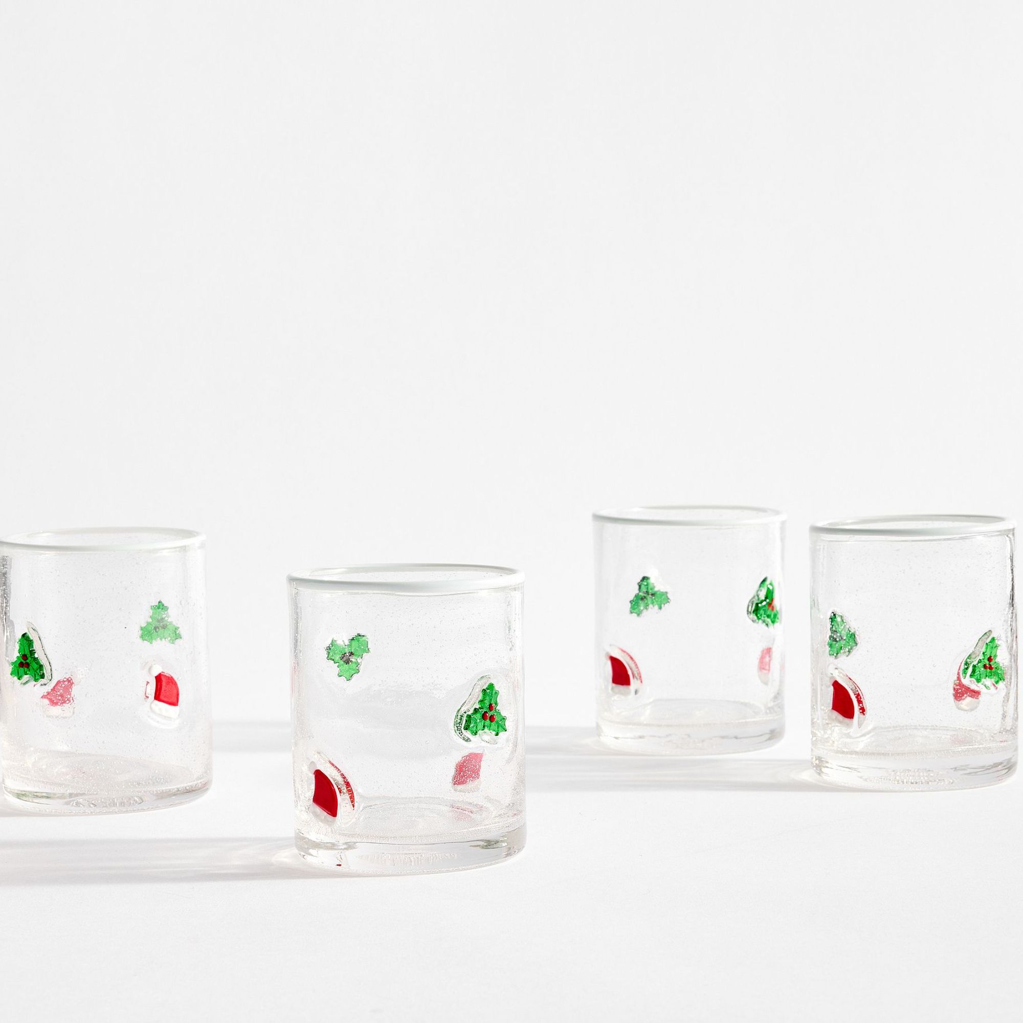 Juice glasses with holly and santa hat motifs