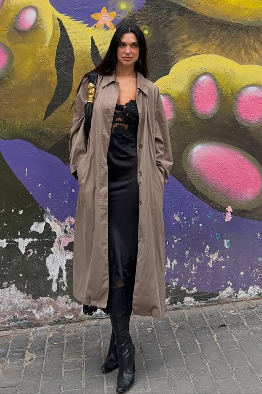 dua lipa wearing a trench coat and black satin dress