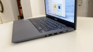 Asus Chromebook Plus laptop open with the screen on, sitting on a desk