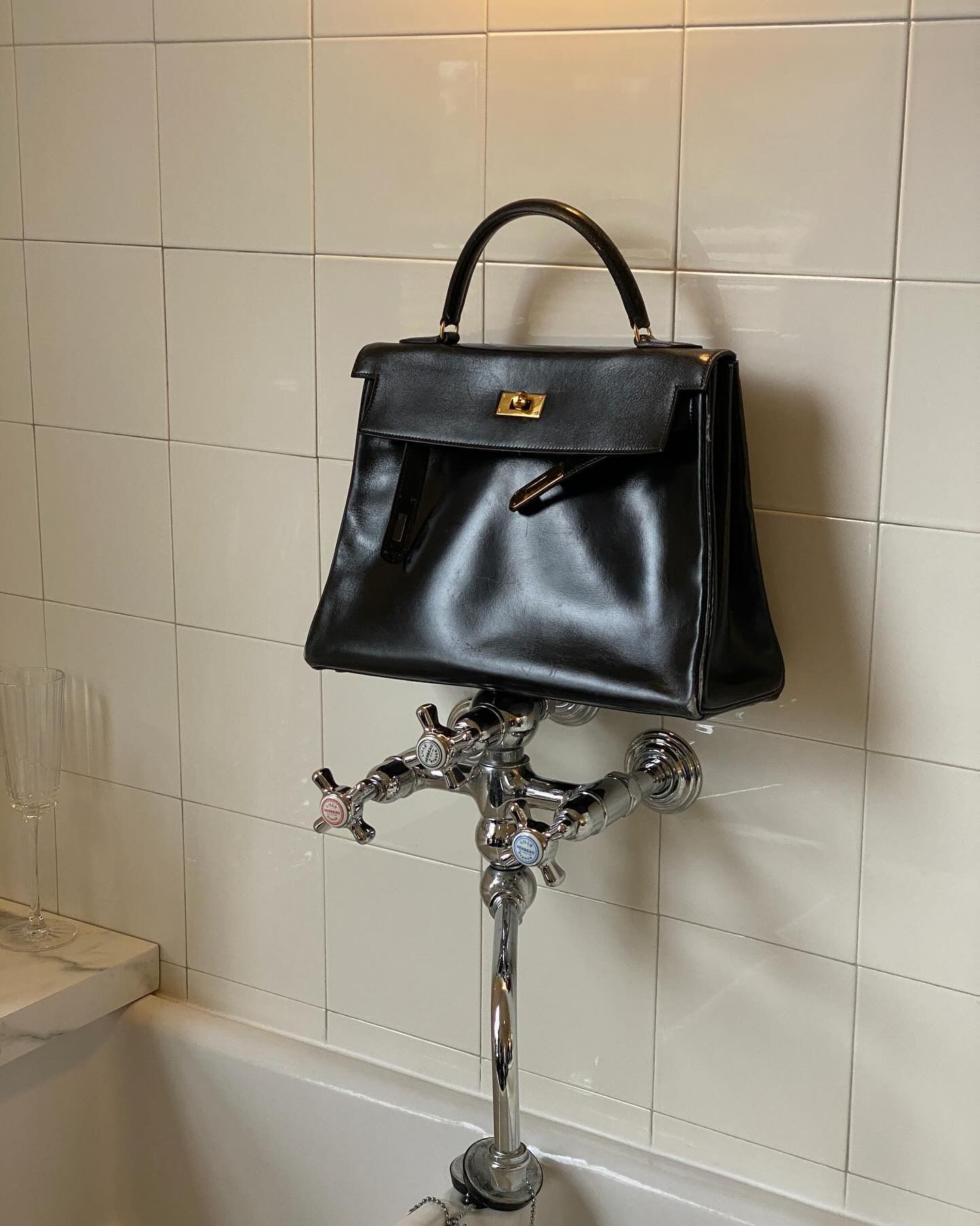 @christietyler taking a picture of a Hermes Kelly handbag